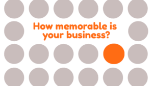 Visual concept showing one bright orange circle standing out among grey circles — symbolising how a memorable brand stands out in a sea of sameness.